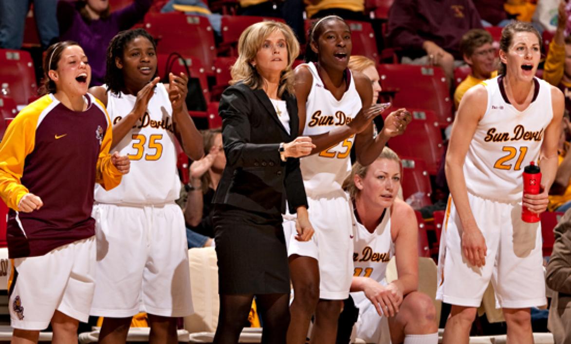 women's basketball team and coach cheering
