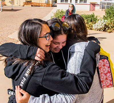 A group of high schoolers hug