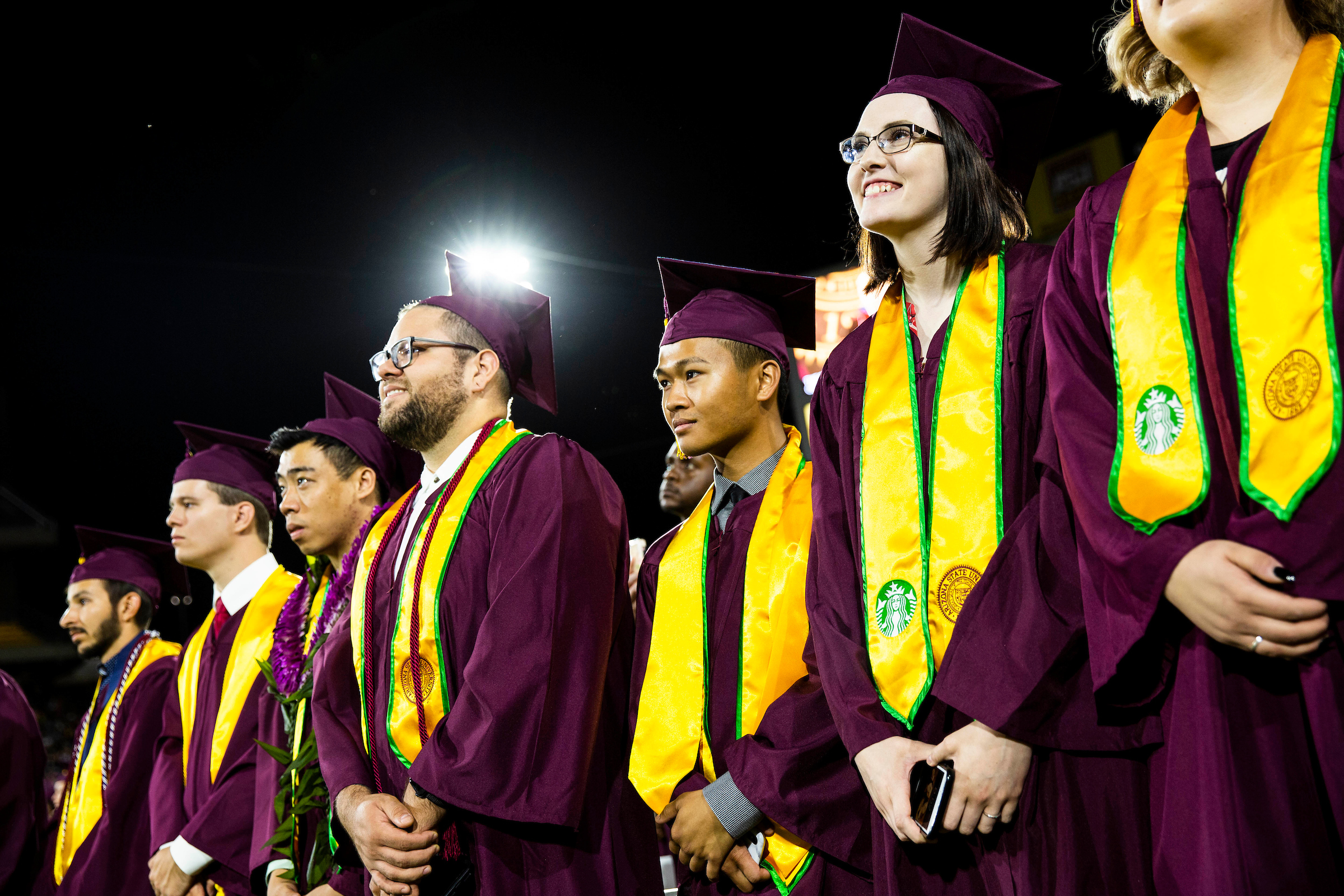A row of graduates listen to the commencement ceremony in May 2019