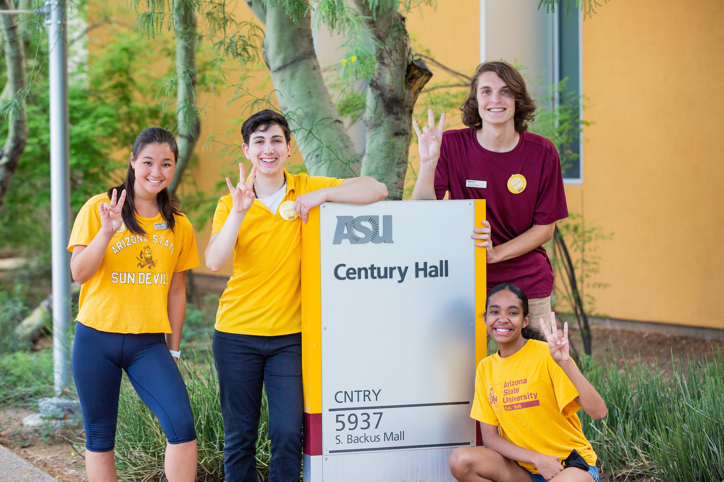 people posing for photo in front of Century Hall residential hall