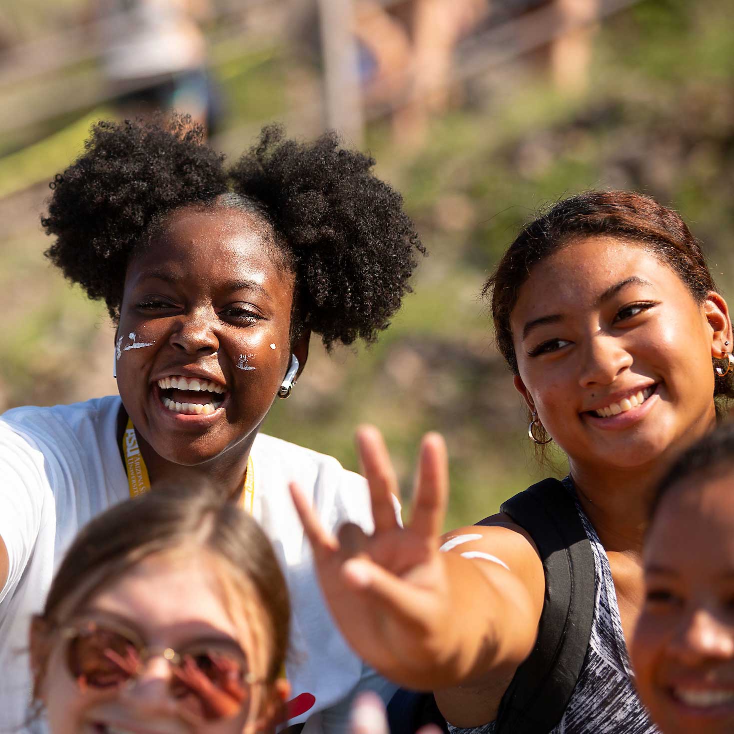 Young women smile in a group during the A Mountain hike