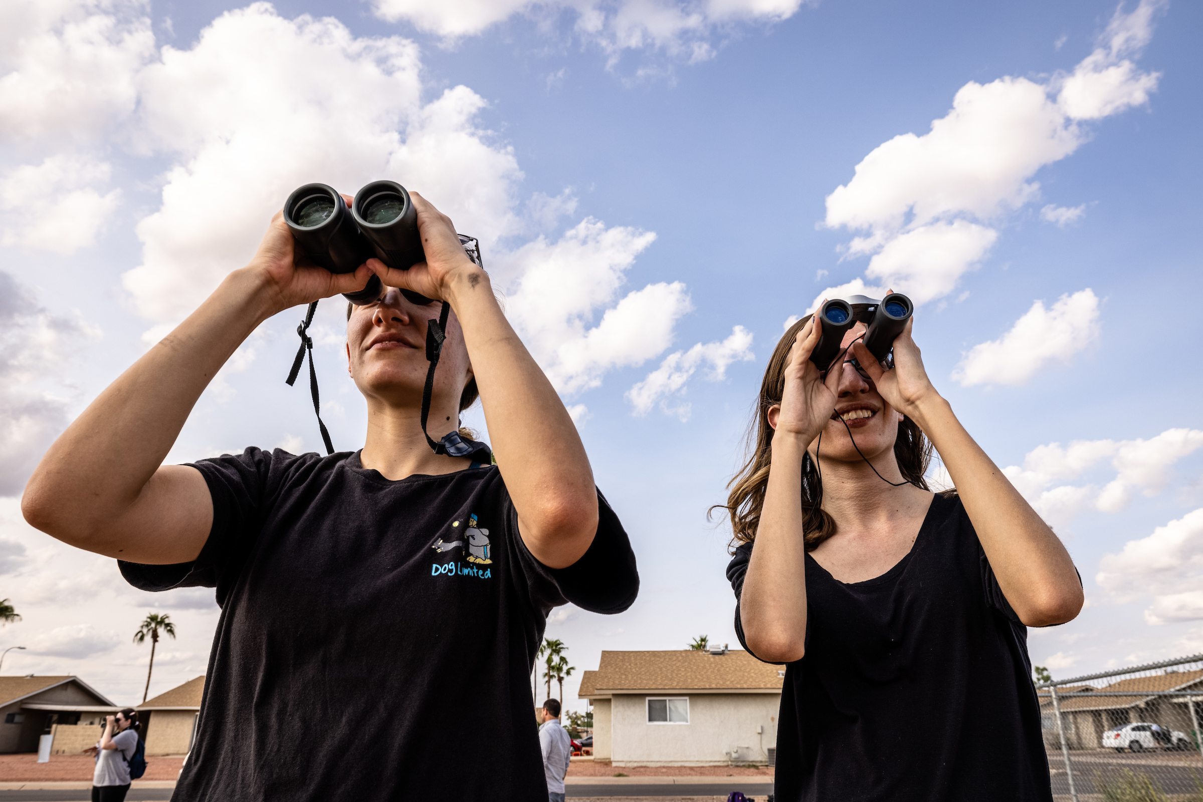 students looking through binoculars 