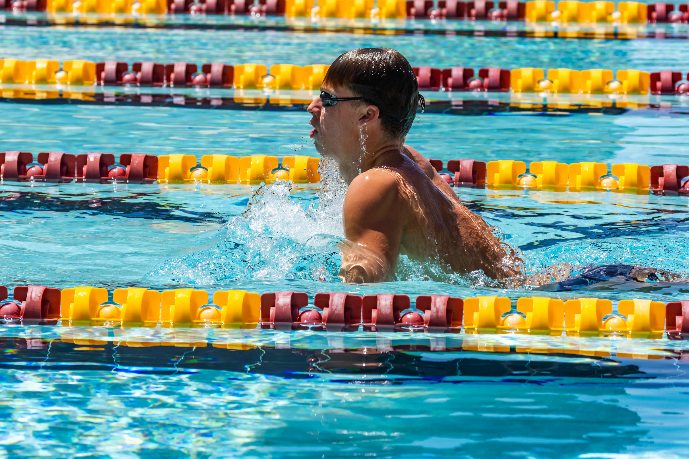 Man swimming in racing pool