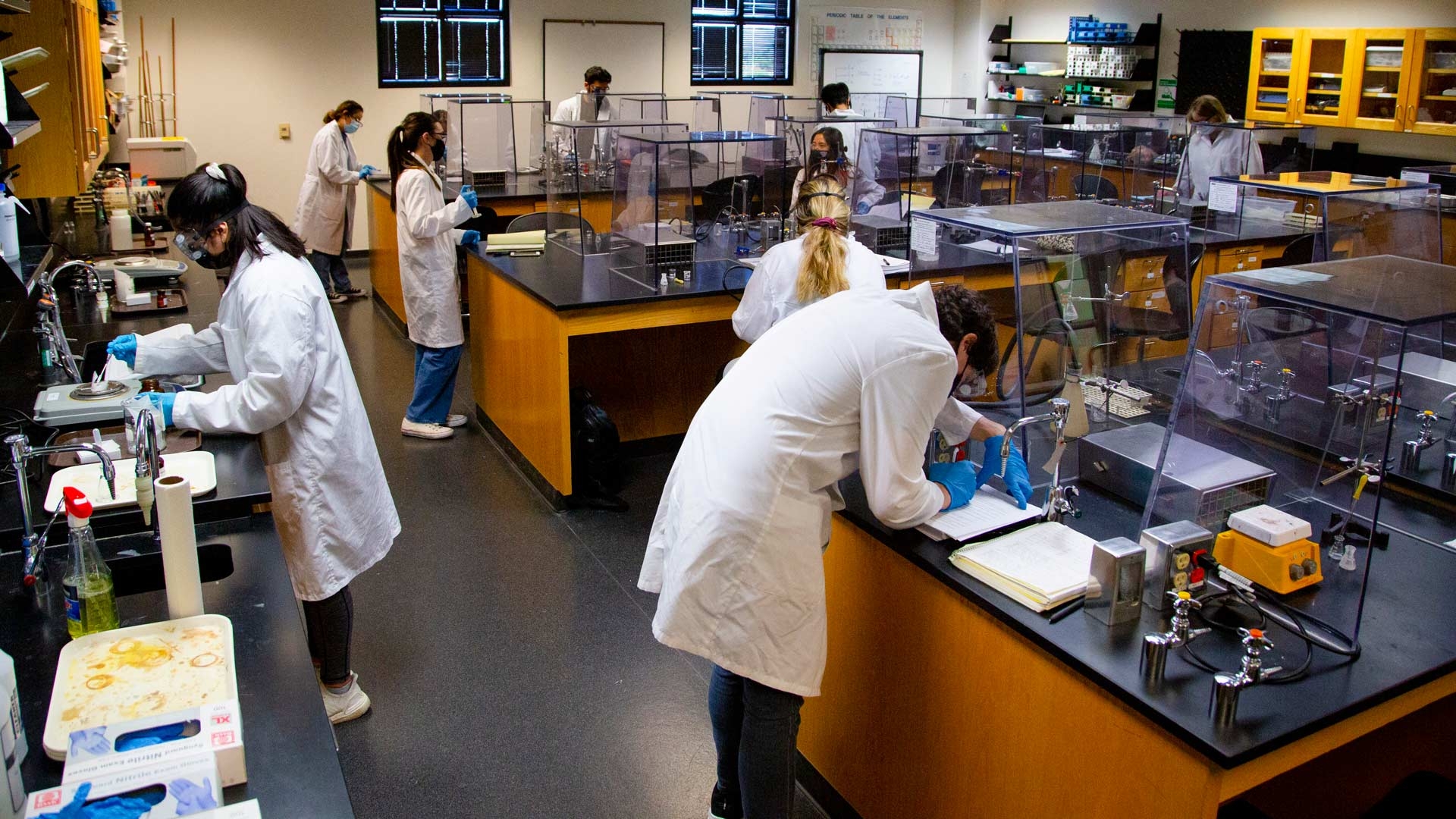 Students work in lab coats in organic chemistry lab at ASU West campus