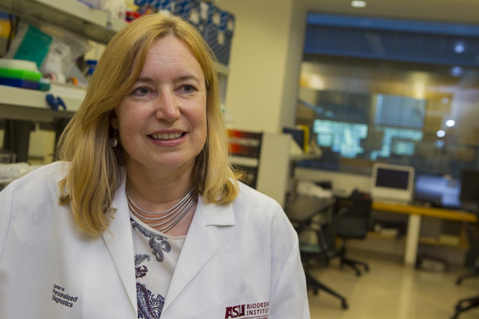ASU Professor Karen Anderson in a white coat in a laboratory setting.