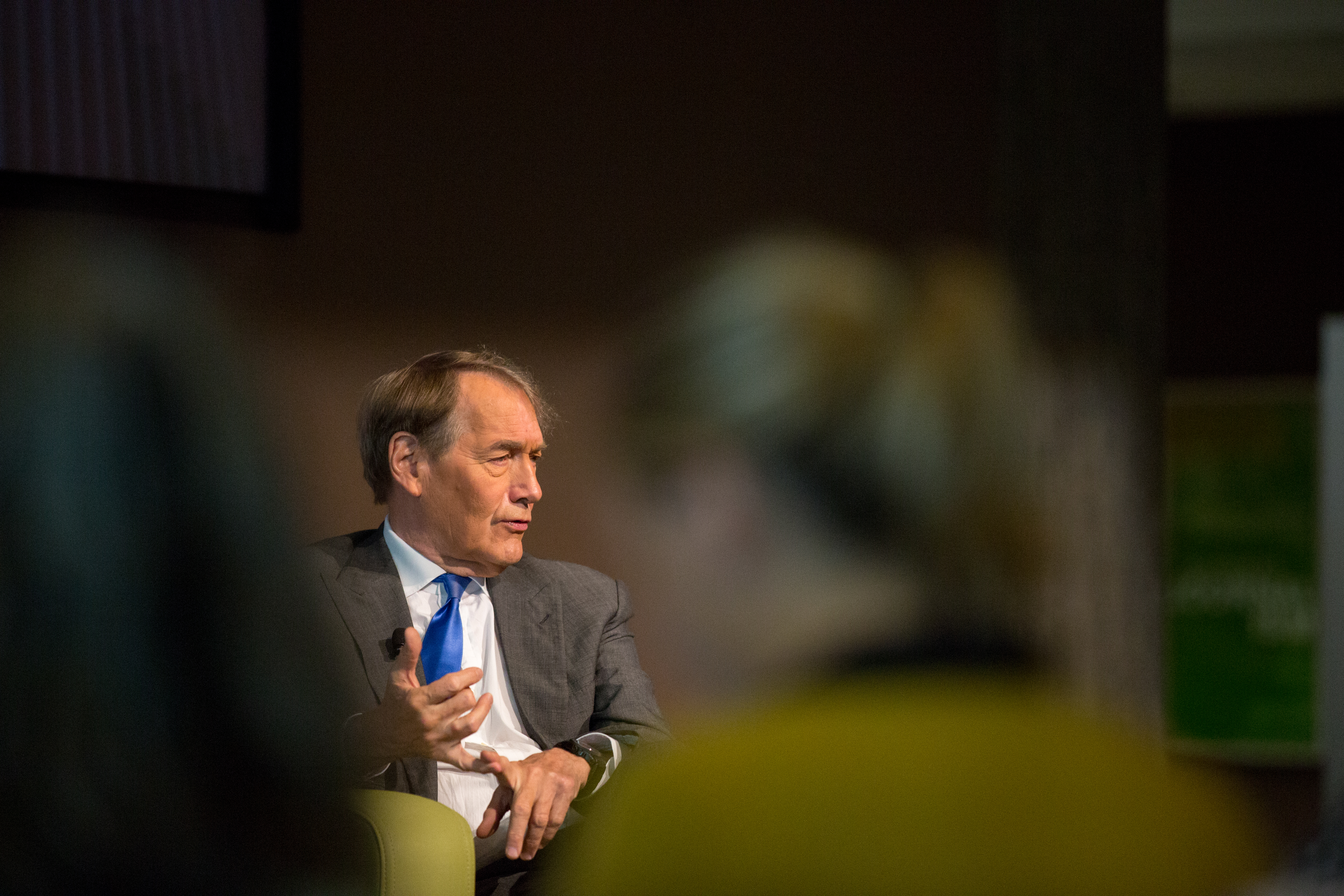 close up of charlie rose on stage speaking to audience