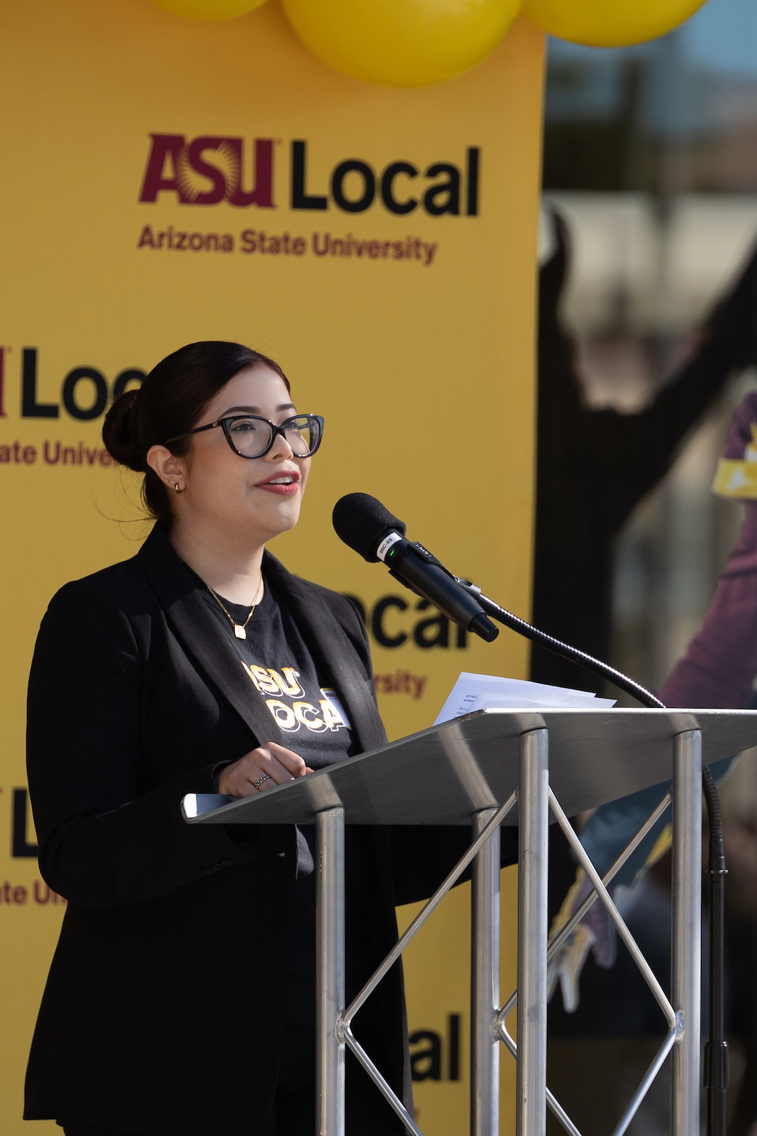 student speaking at lectern at ASU Local event