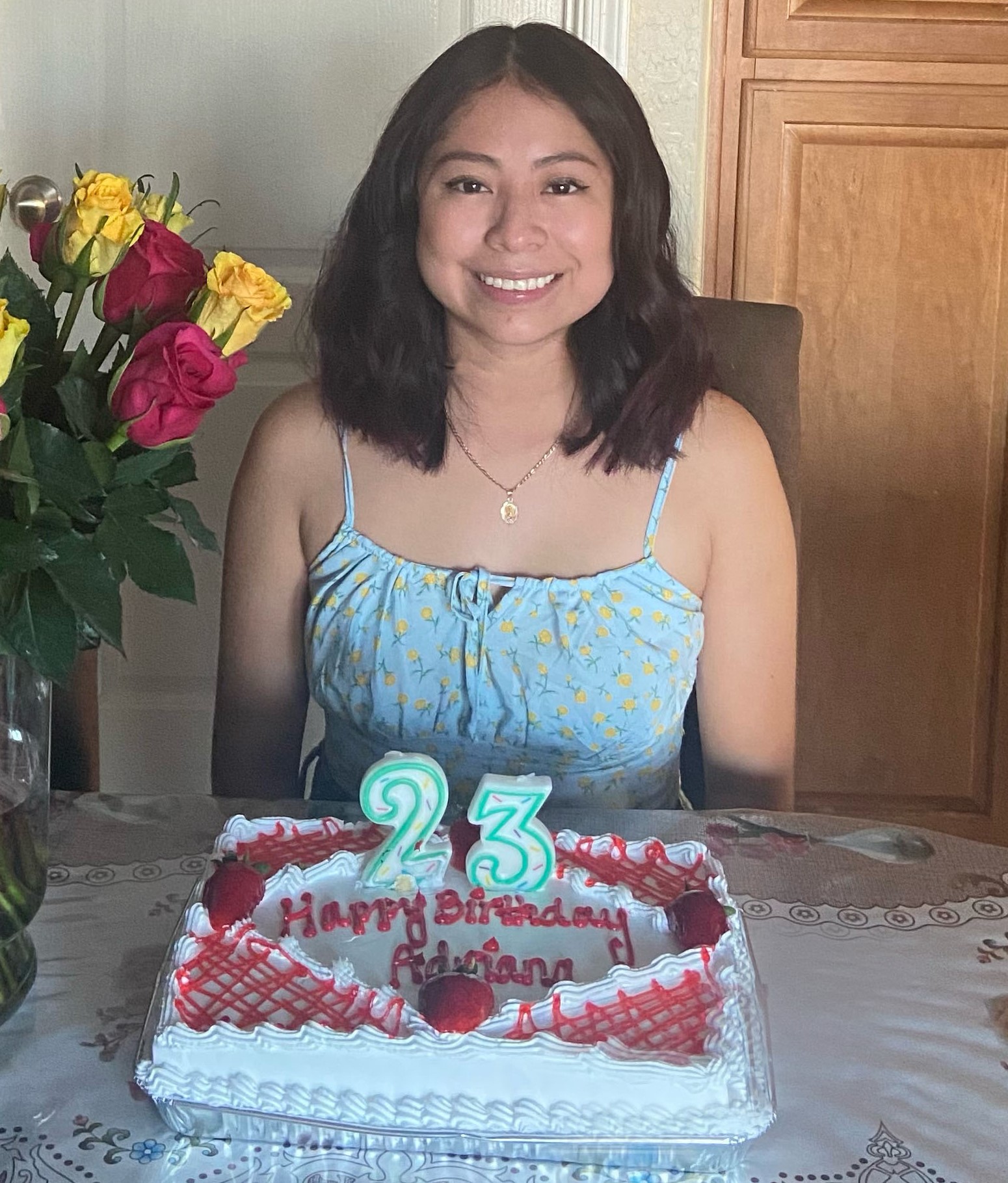 Scholarship recipient  poses with a birthday cake. 