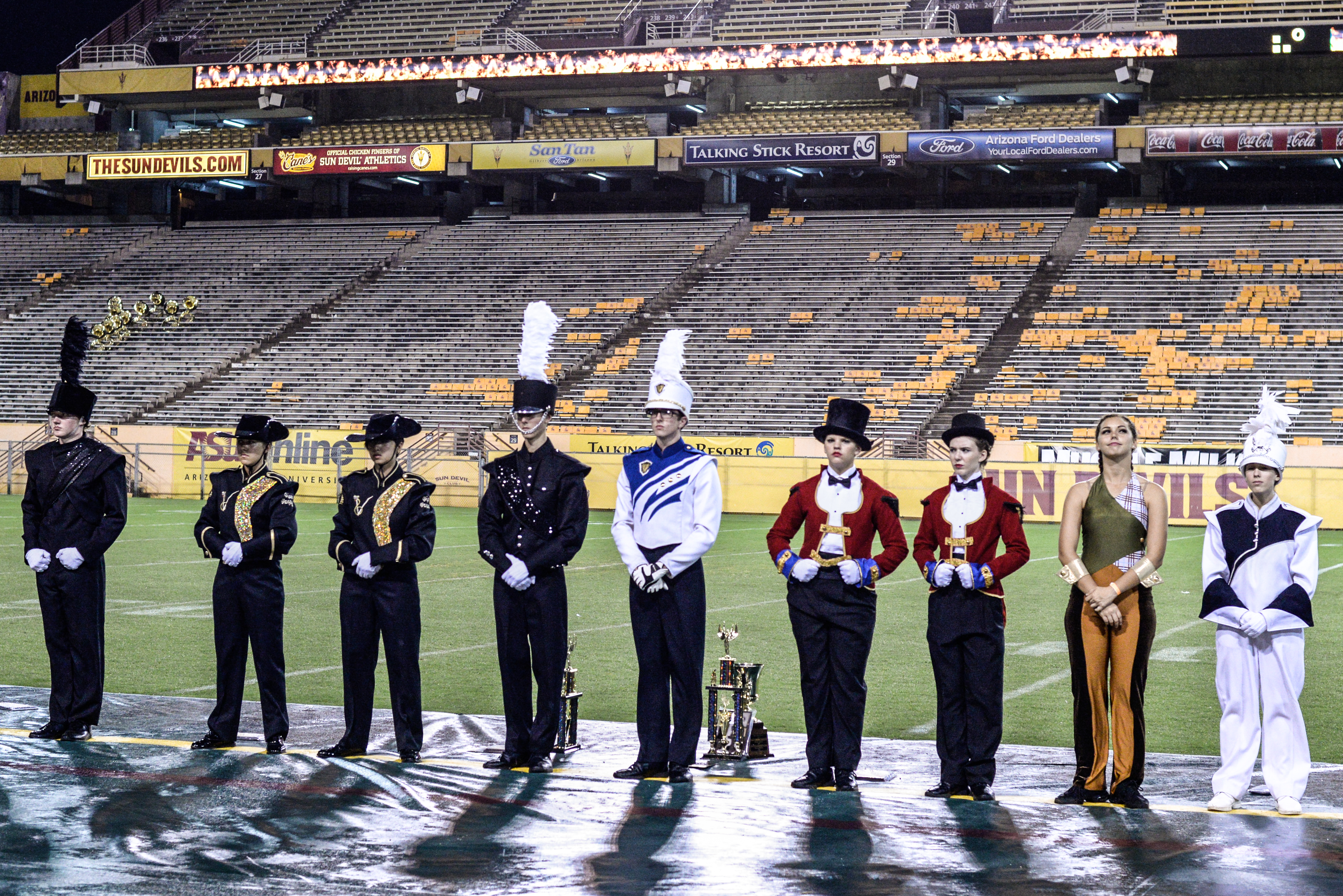 Members of high school marching bands line up at Sun Devil Stadium