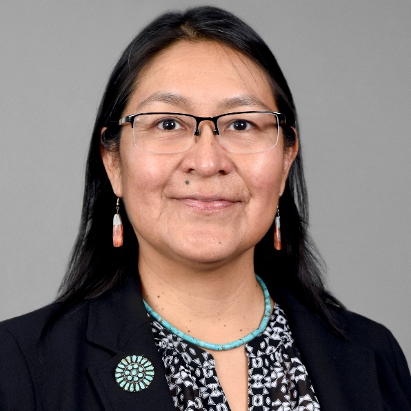 Portrait of Native American woman with long dark hair wearing glasses