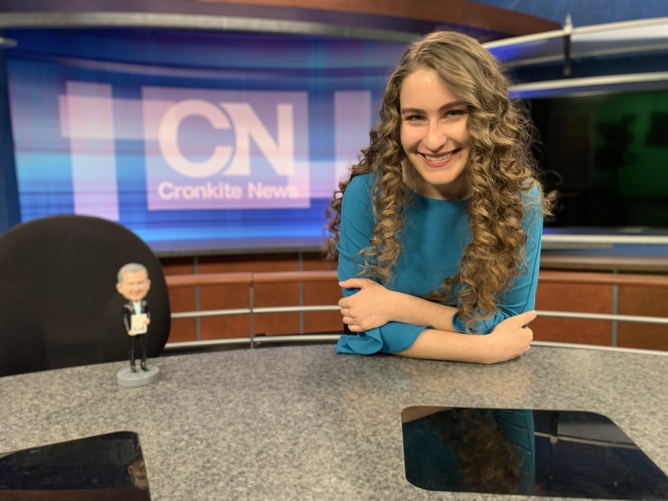 ASU Cronkite student sitting at news desk