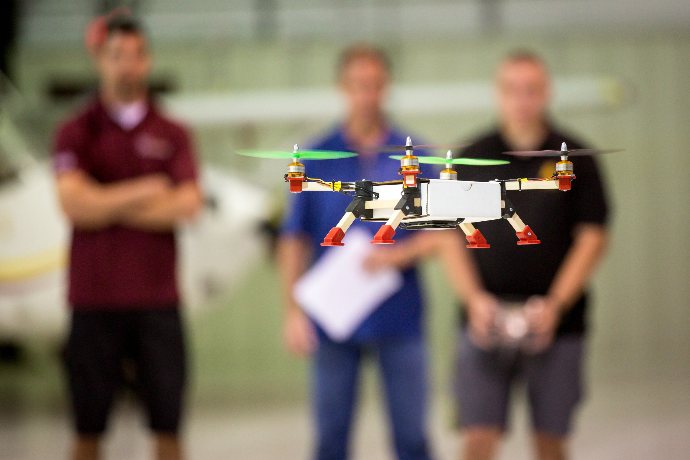 A student-made drone flies in an ASU hangar.