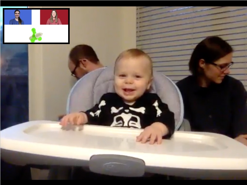 baby in a high chair smiling