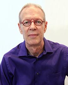 Man in purple shirt and glasses