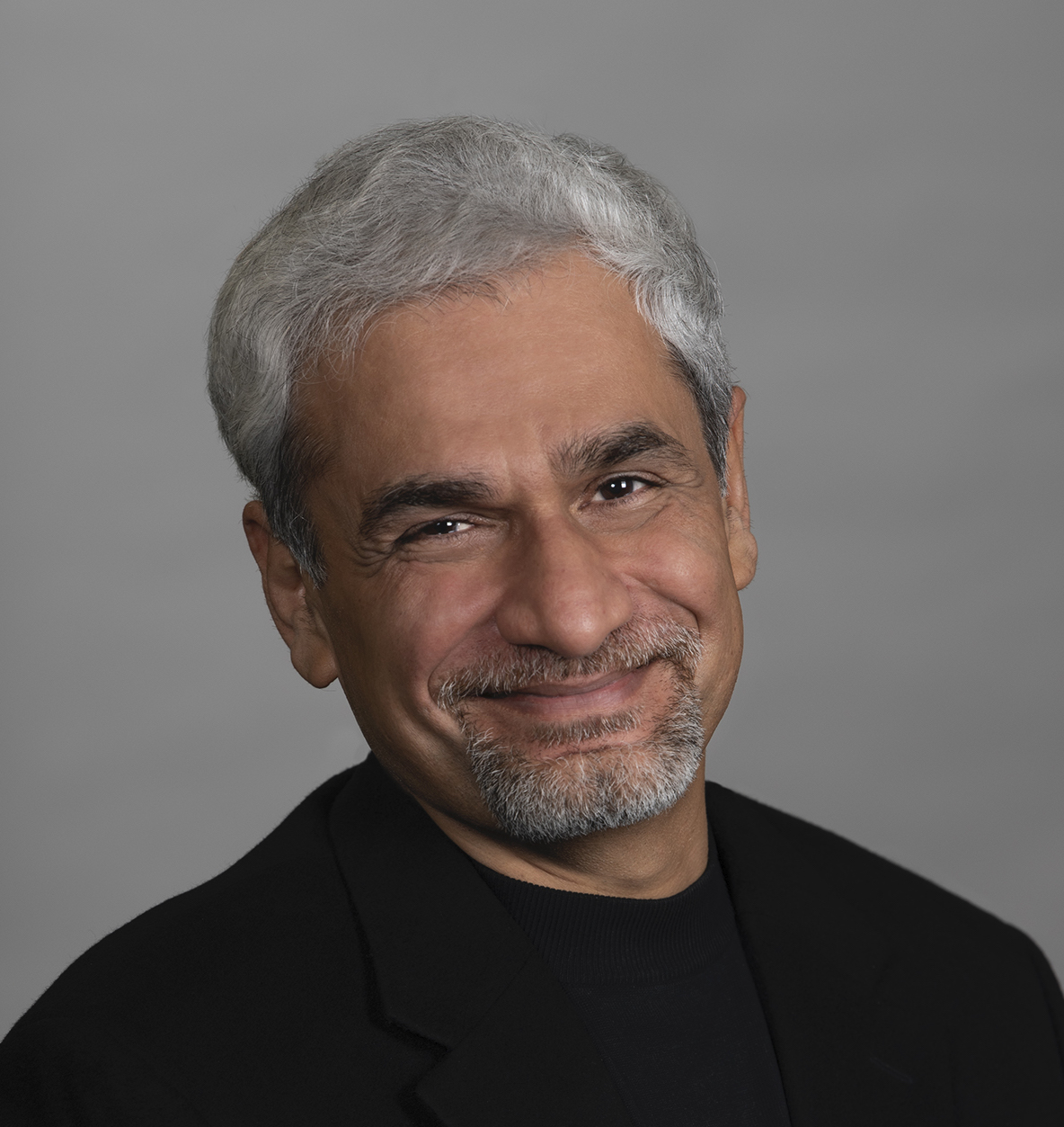 Man with grey hair and black shirt