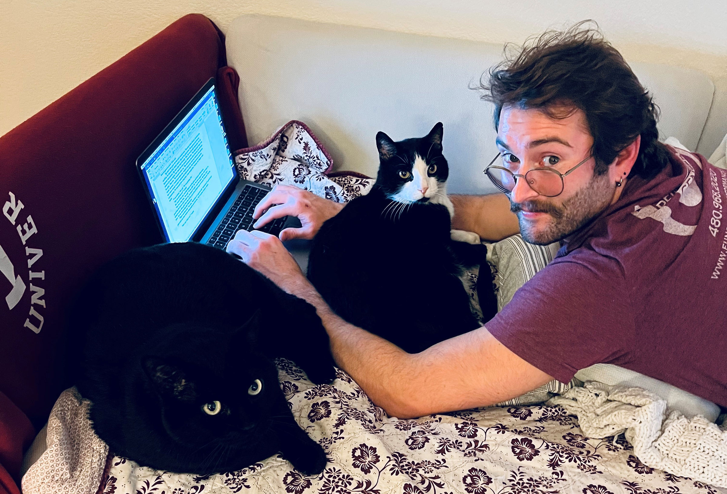 Graduating ASU student Colin Bonini works on his fiction while surrounded by ever-present writing partners.
