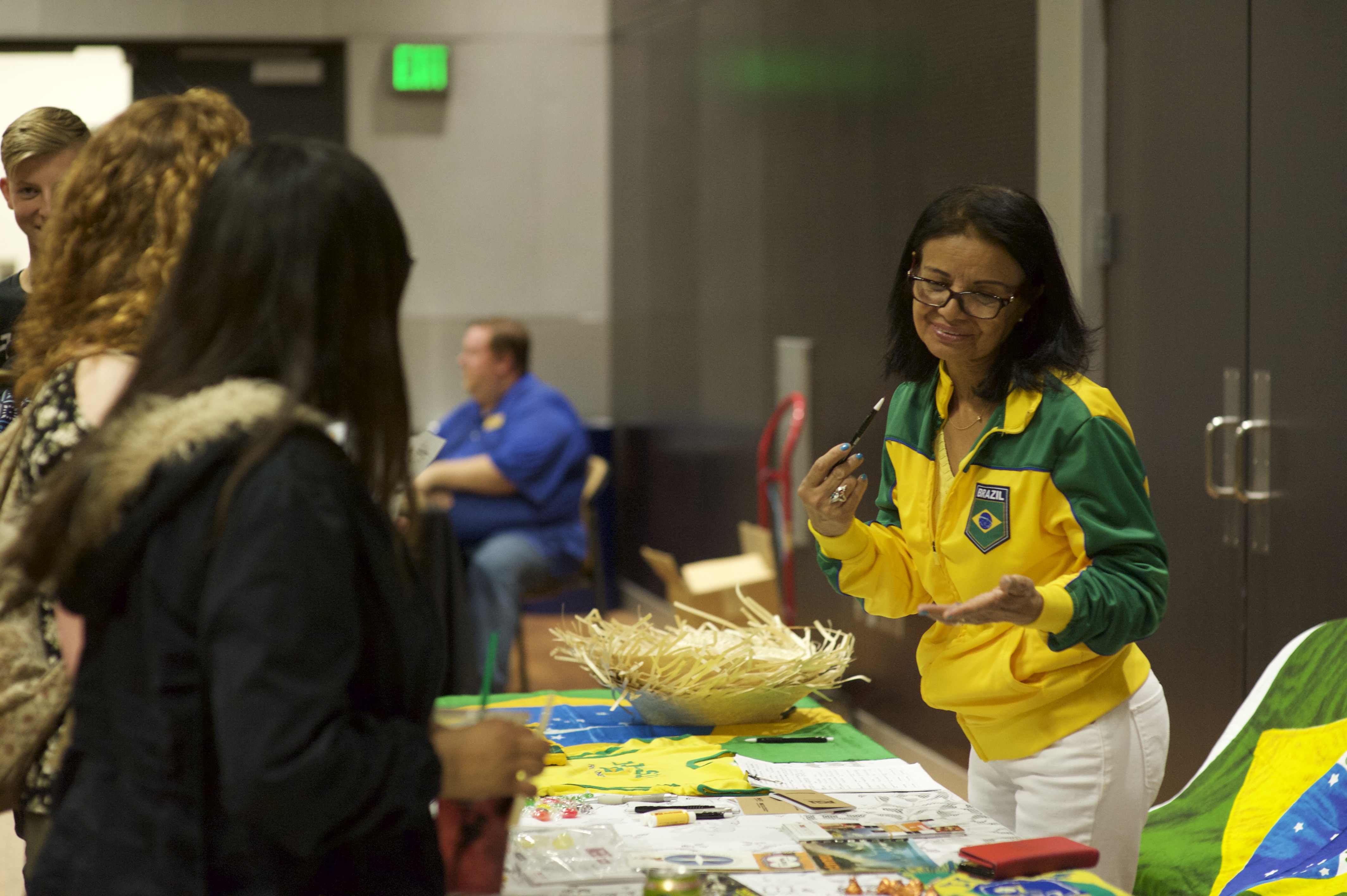 A faculty member talks about Portuguese with prospective students at the Language Fair