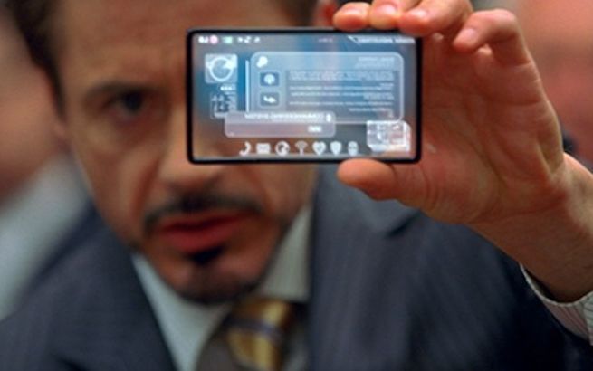 A man holds up a see-through phone.