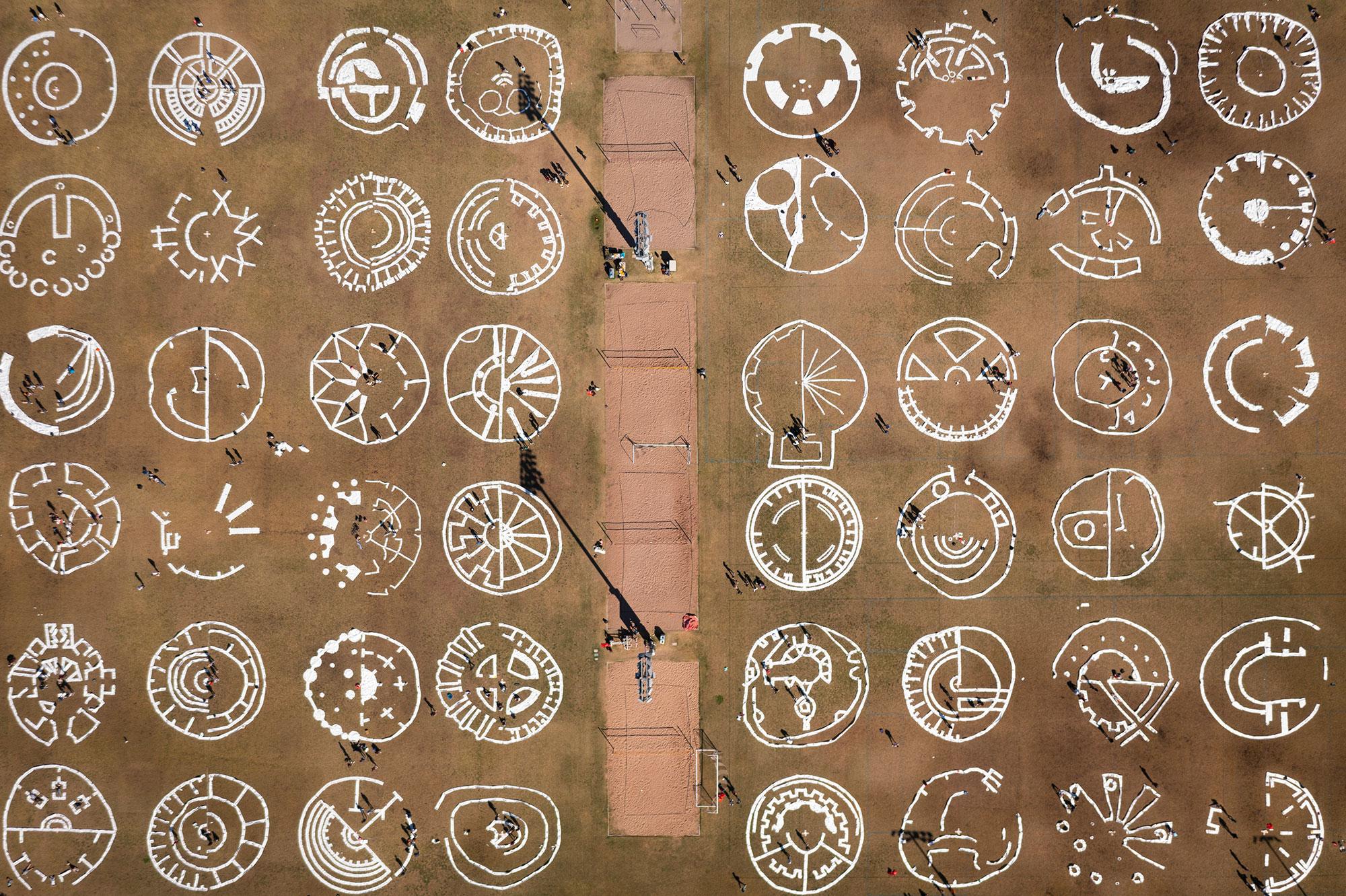 Aerial view of circular images produced by architecture students on a field.