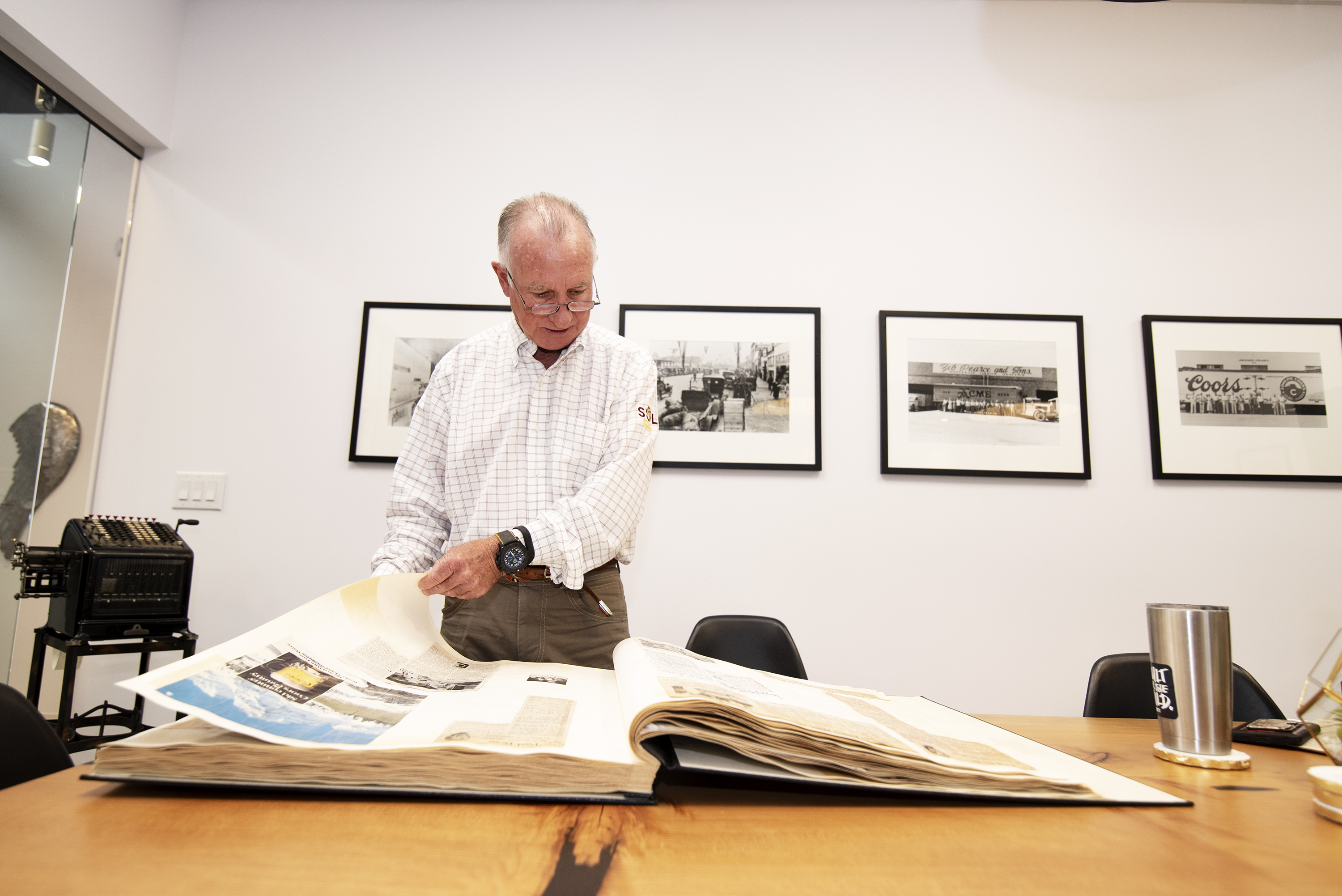 Arthur "Art" Pearce looks through a scrapbook of a news clippings and other memorabilia documenting his grandfather Zebulon's legacy at ASU. 