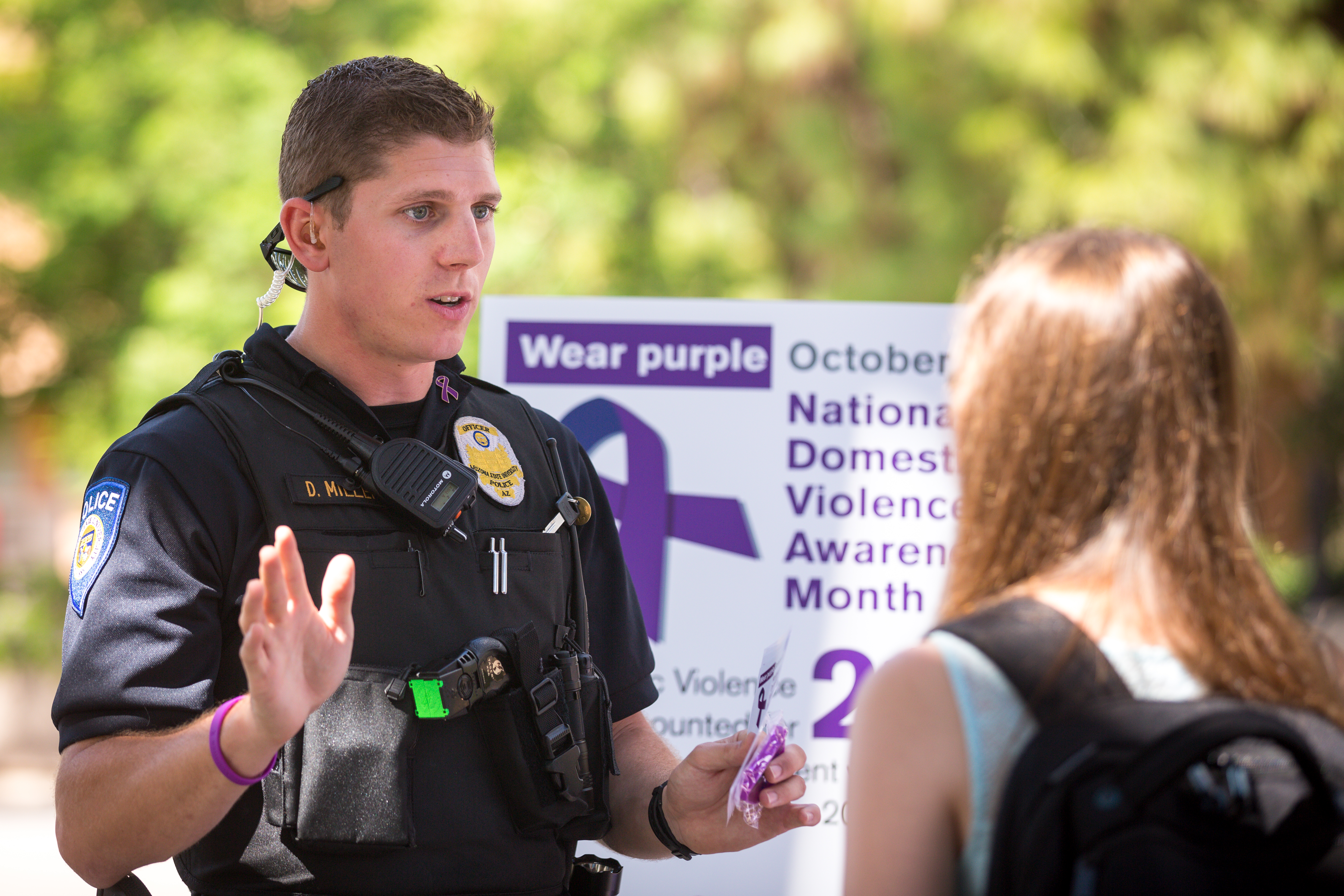 Photo of ASU Police Officer Daniel Miller and student during Domestic Violence Awareness Month