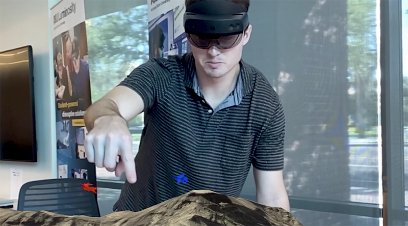 ASU graduate student Dylan Kerr demonstrates the Next-Gen Debrief 3D augmented reality system.