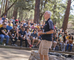 man speaking to students at camp
