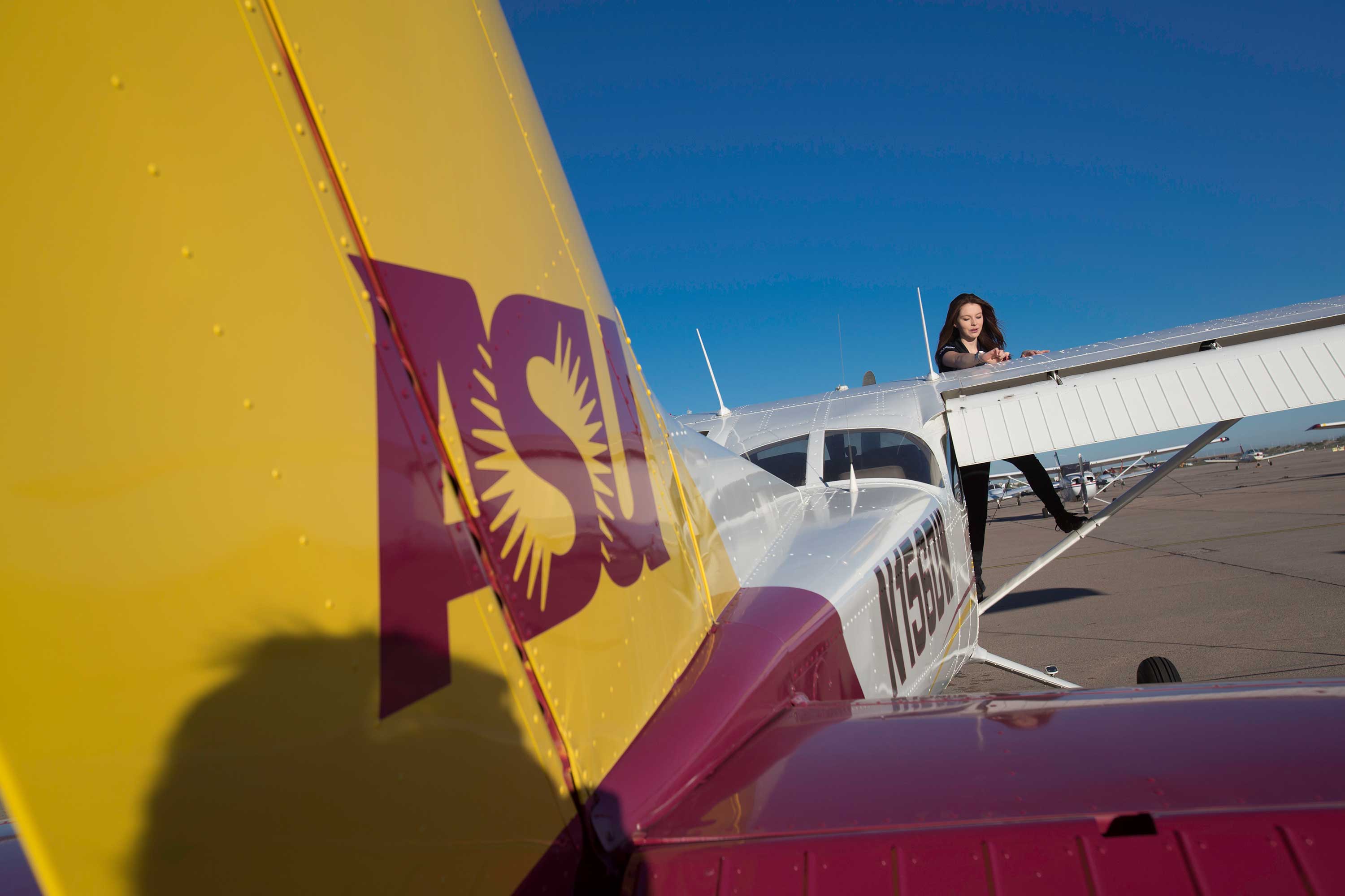 Student working on plane with ASU logo on it