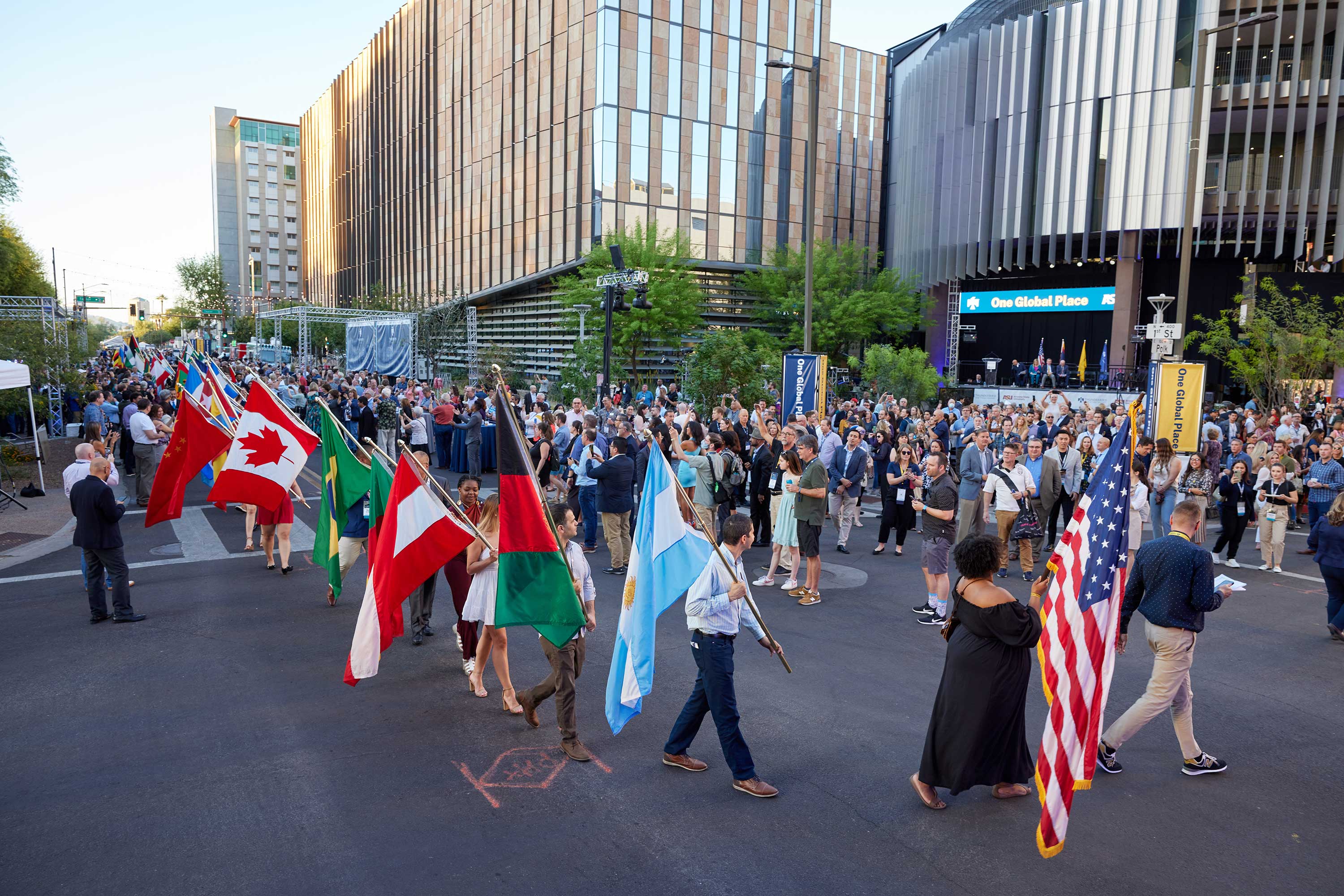 People walking in parade with flags from around the world