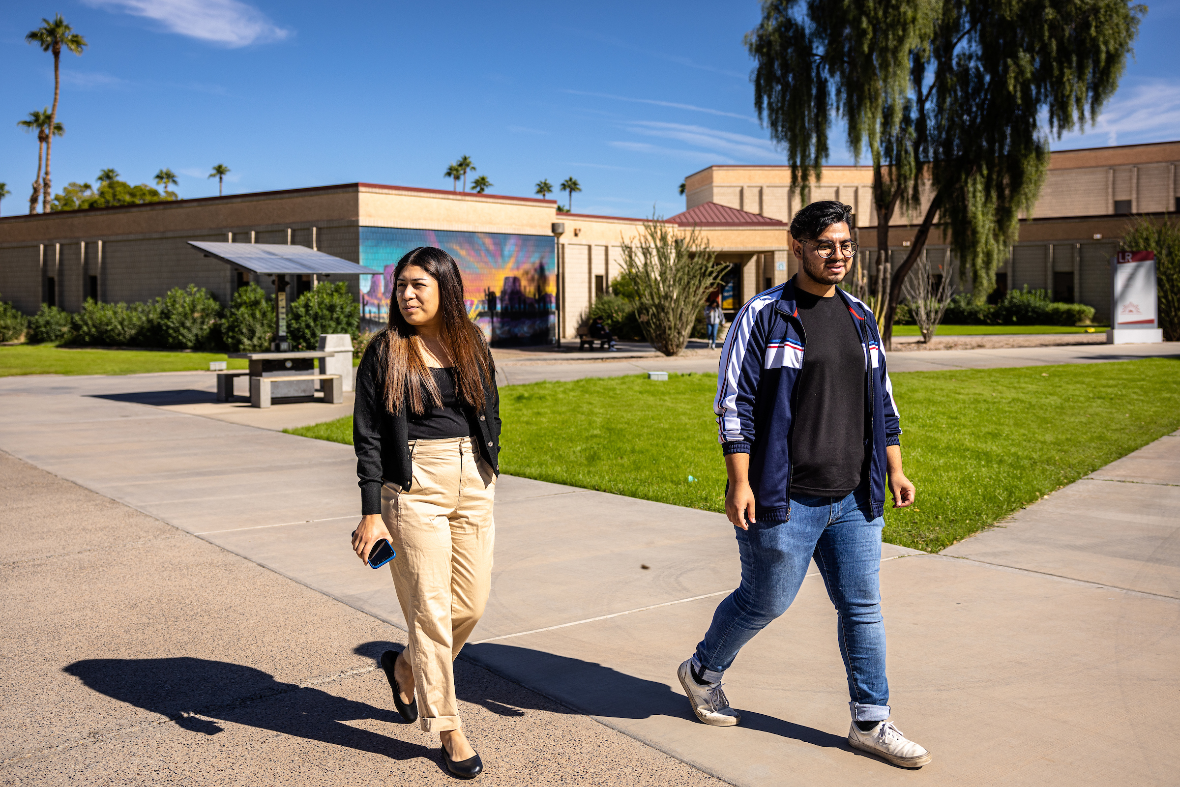 Two students walking on Yuma community college campus
