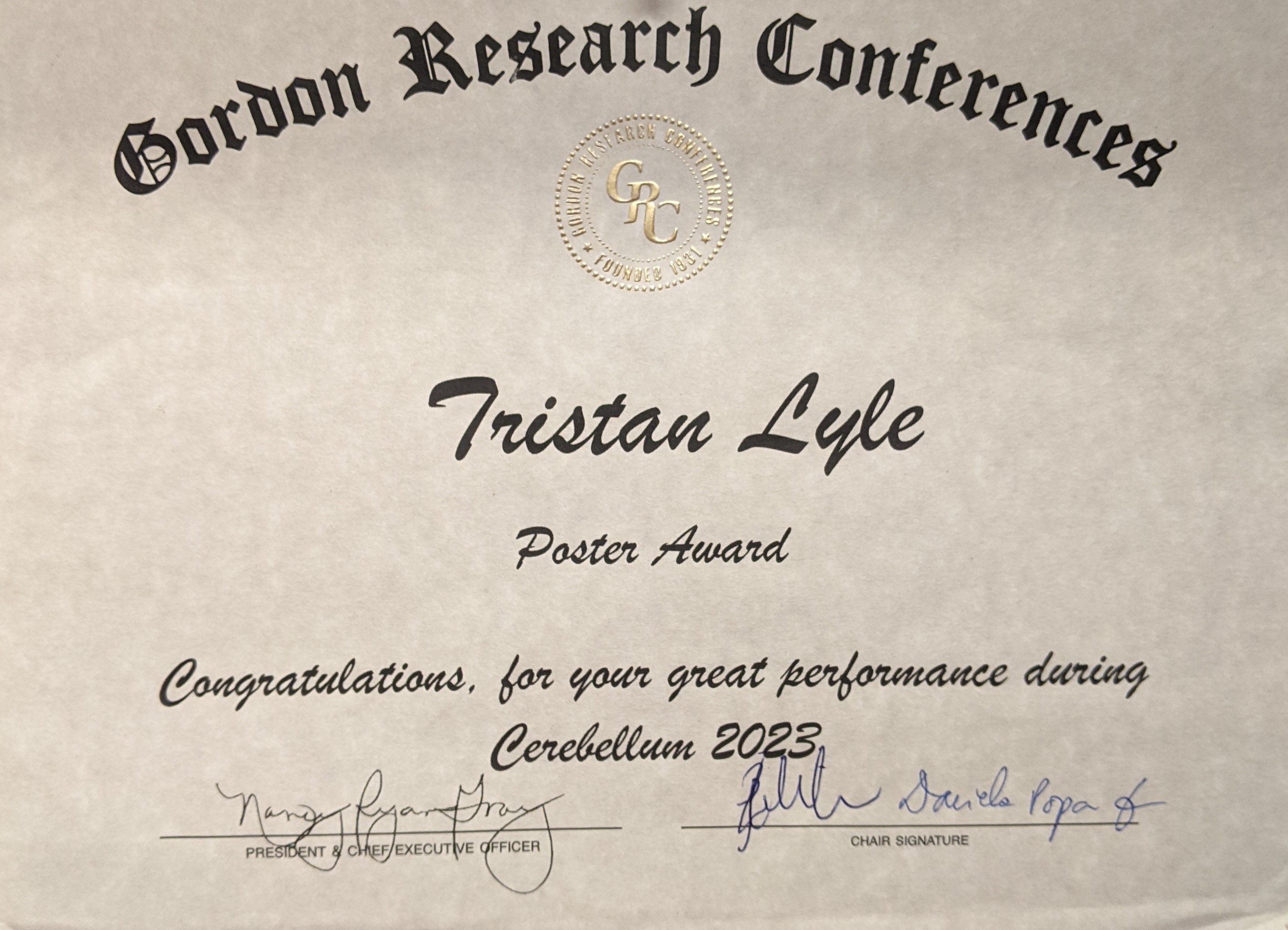 A poster award certificate presented to Tristan Lyle from the Gordon Research Conferences.