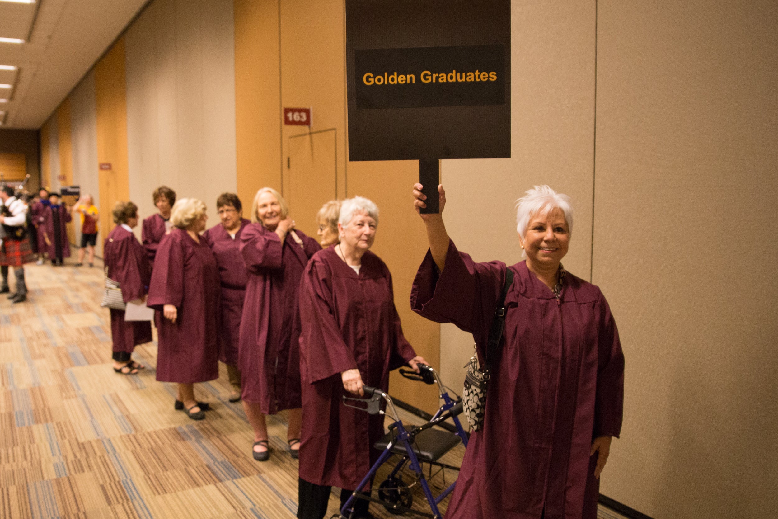 line of ASU nursing Golden Grads in graduation gowns