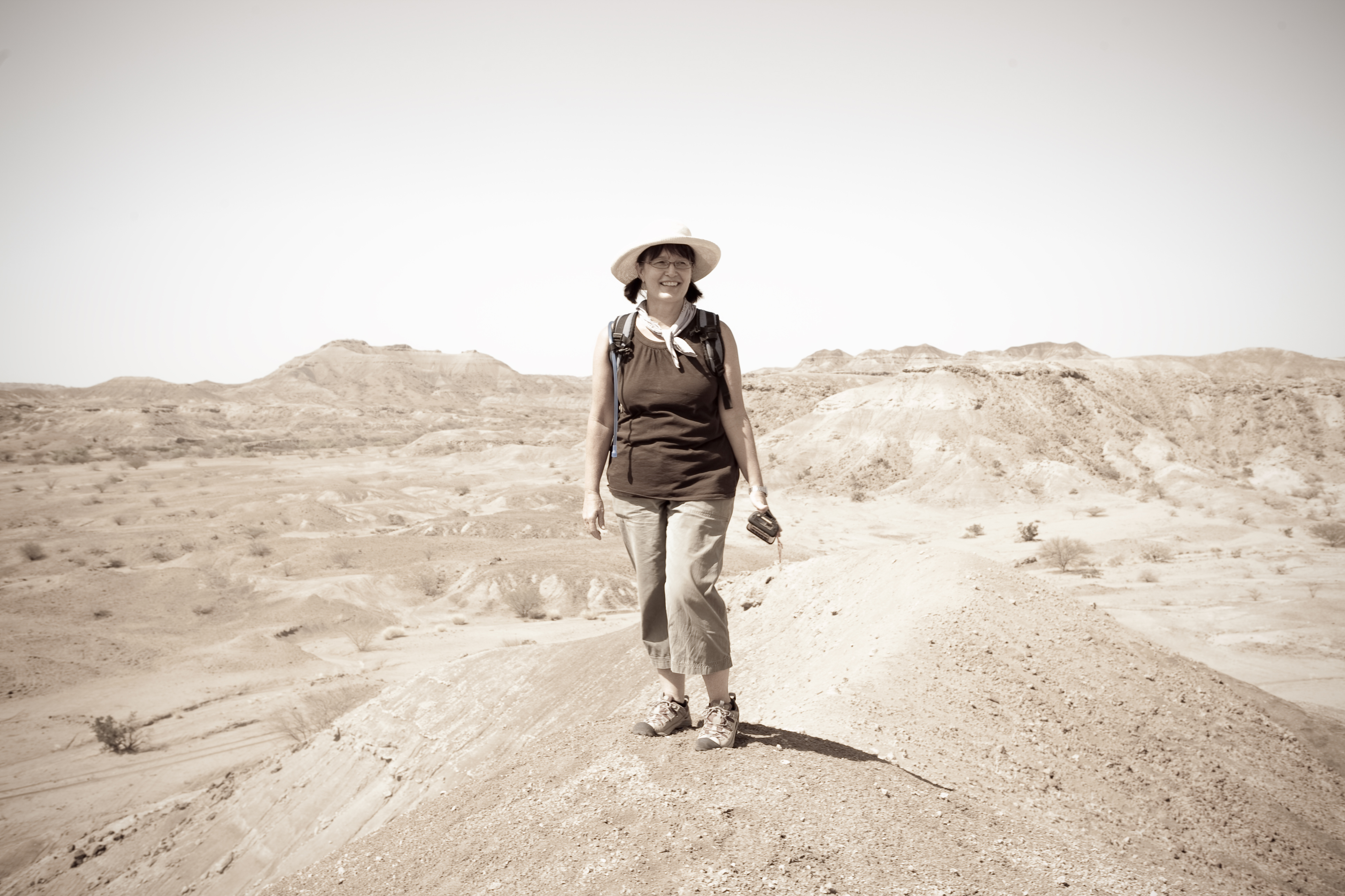 Portrait of a woman standing in a desert in hiking gear