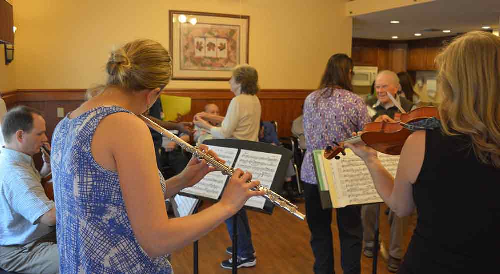 people playing music at assisted home