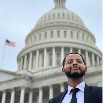 A man poses in front of the US Capitol in Washington DC