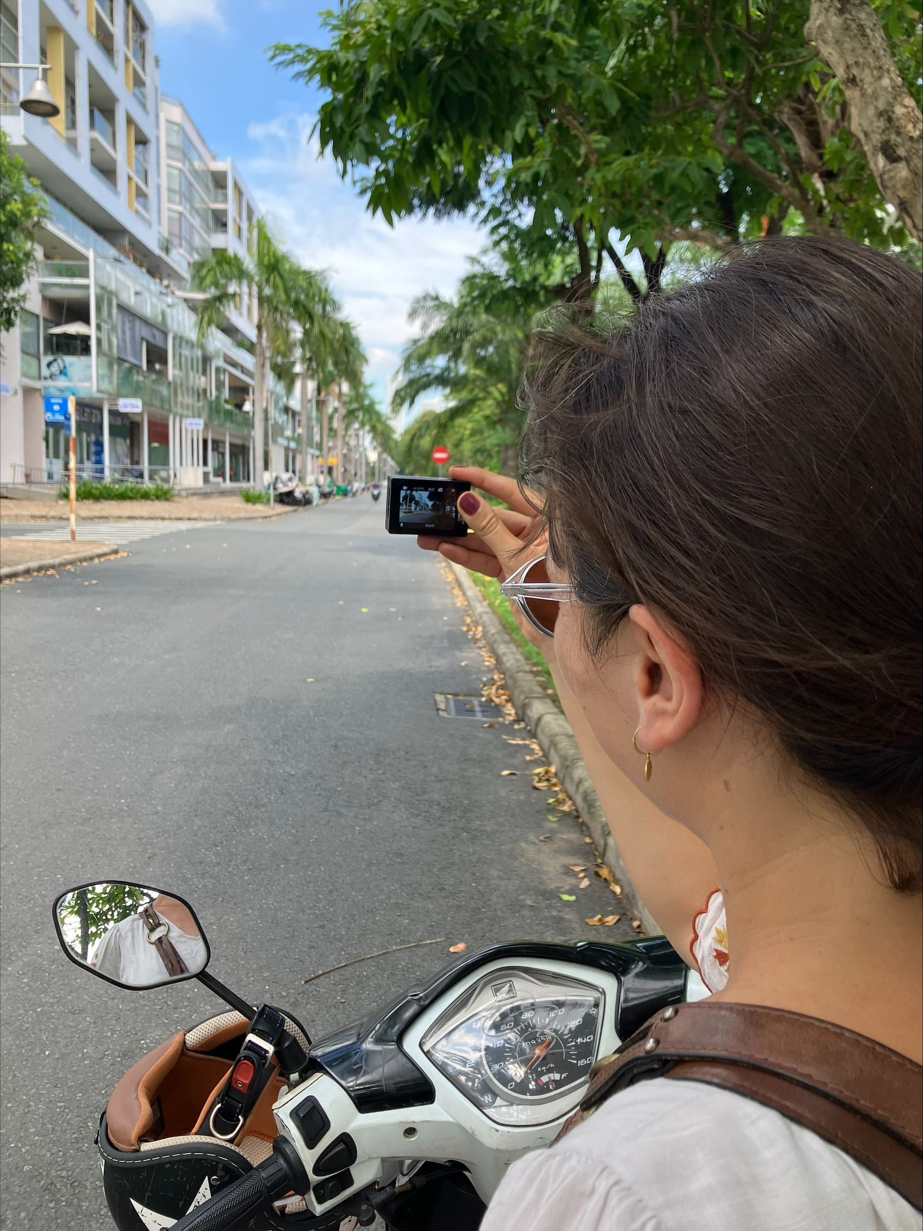 Woman taking video from her motorbike in Vietnam