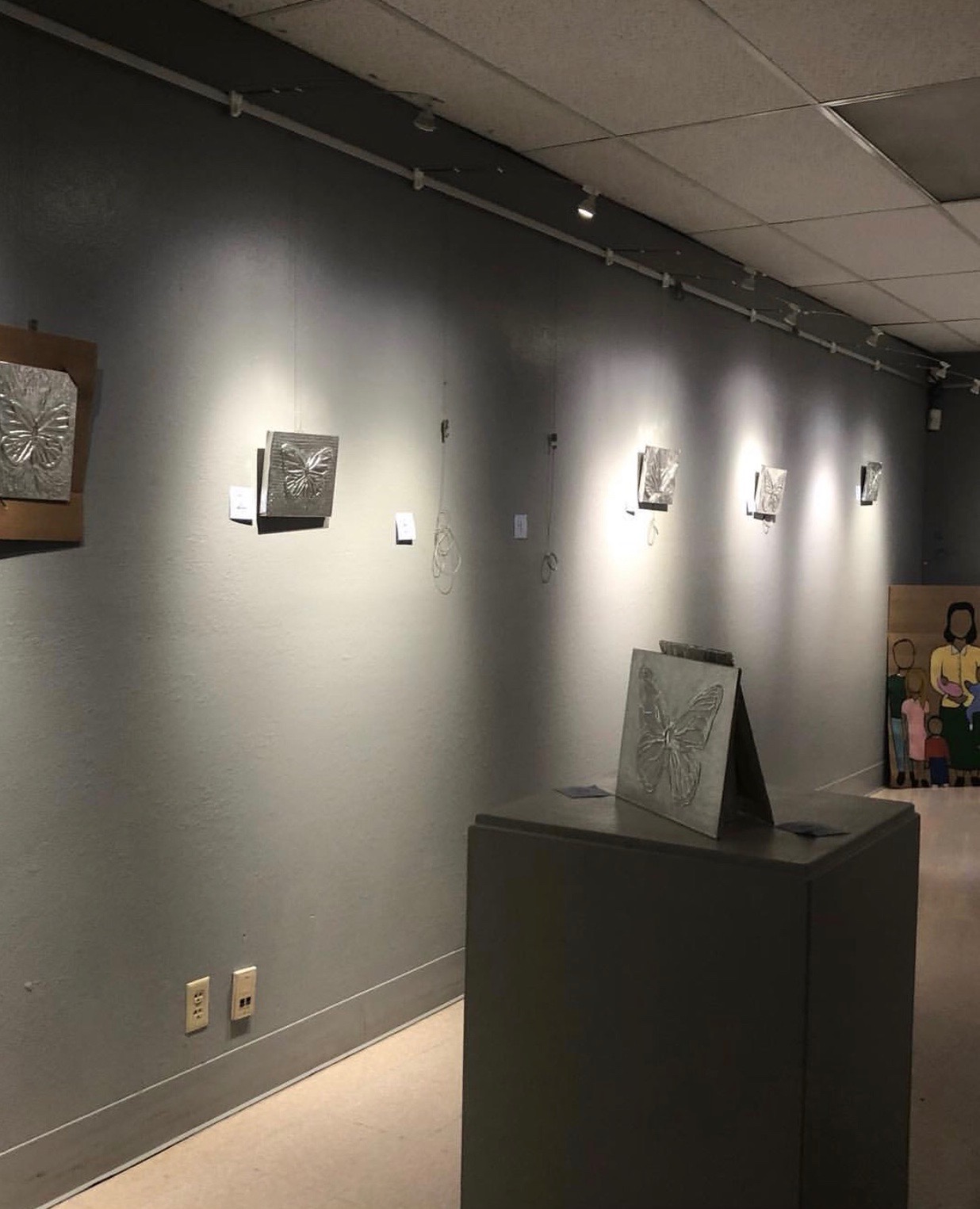 The class' repujado art pieces hanging in the Phoenix Center for the Arts