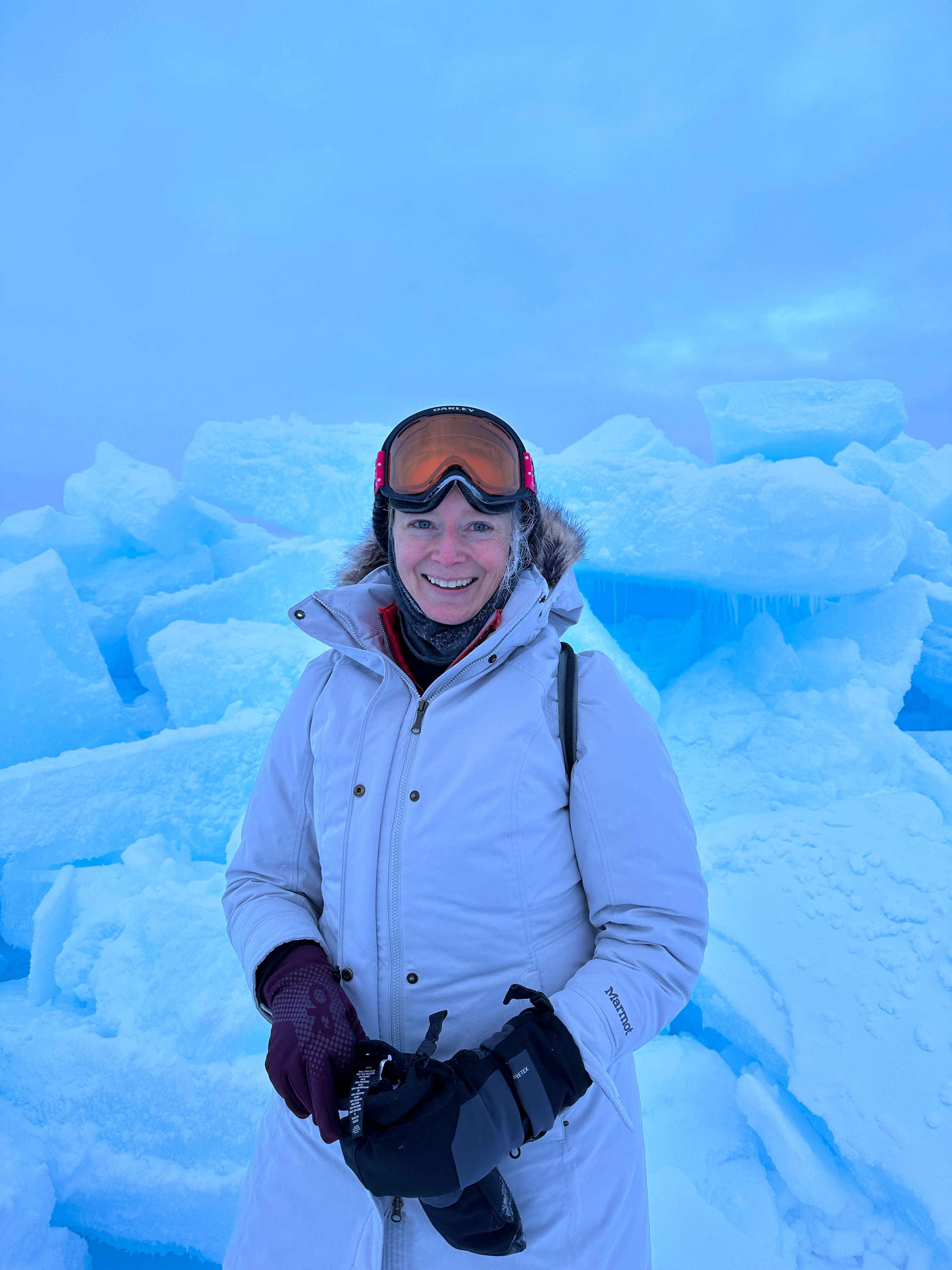 Woman standing near a first-year sea-ice pressure ridge