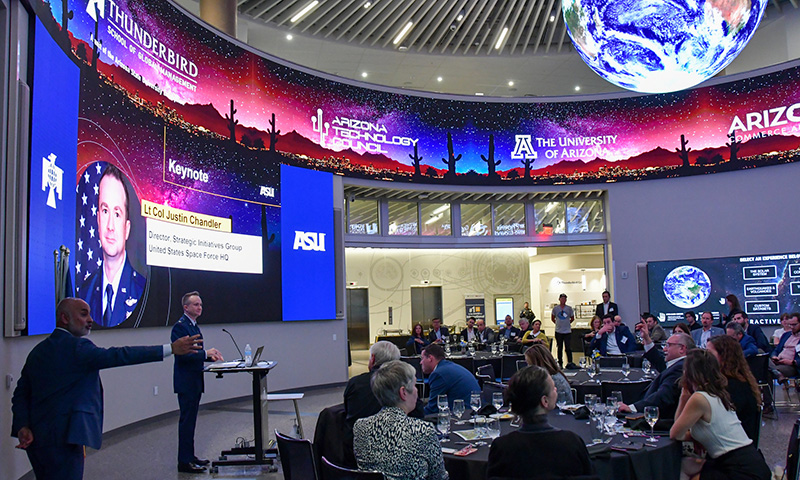  Lieutenant Colonel Justin Chandler speaks to a seated audience during the Arizona Space Summit reception on ASU’s Downtown Phoenix campus.