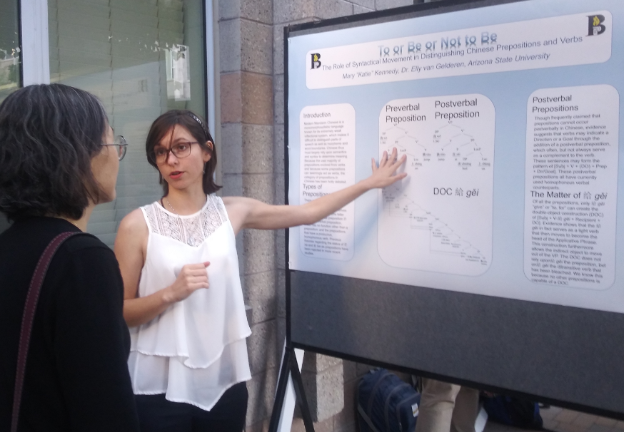 Katie Kennedy explains her linguistics thesis to a poster session visitor. / Photo by Elly van Gelderen