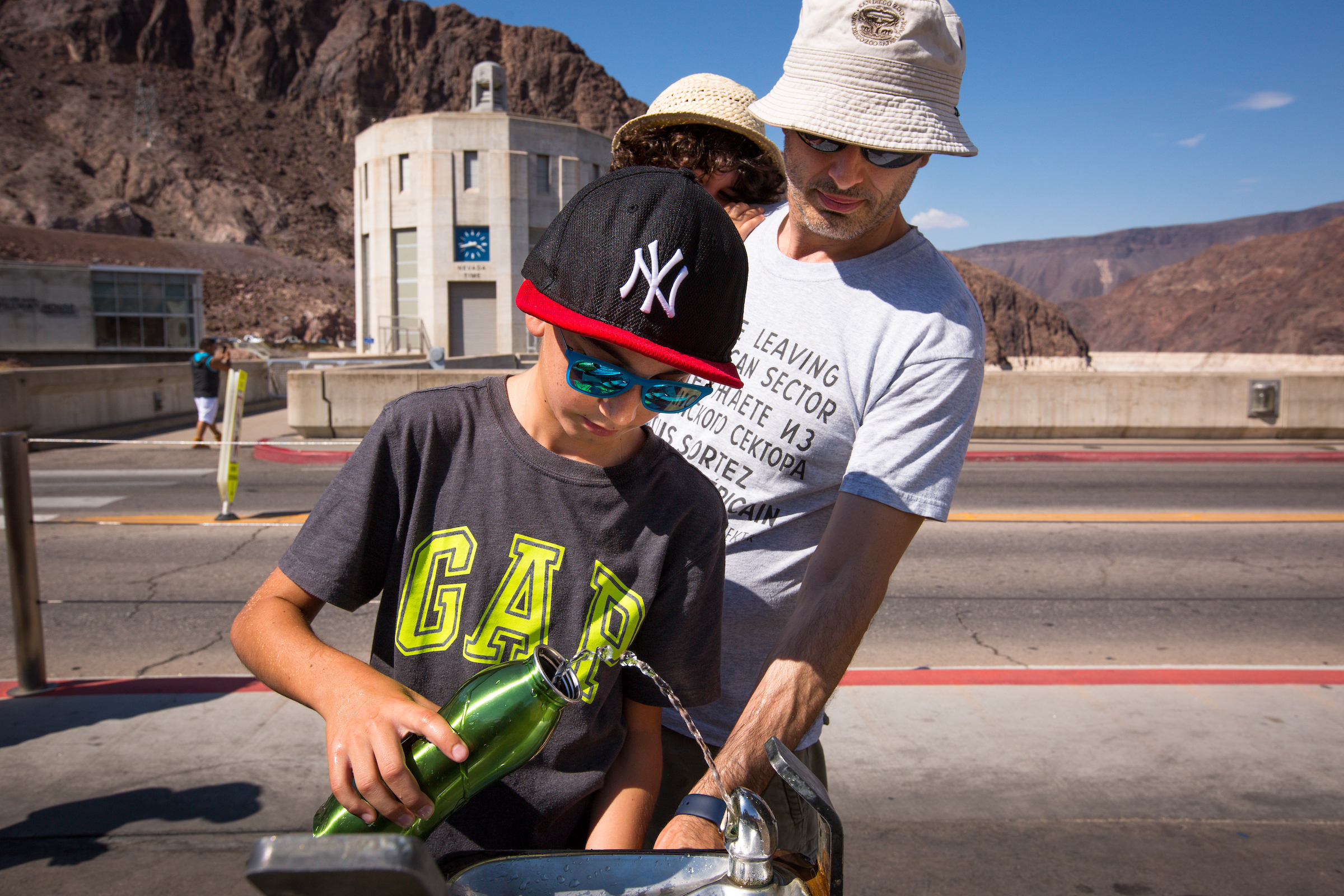 Tourists fill up a water bottle at Hoover Dam.
