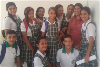 Larissa with several Colombian students in their school uniforms.