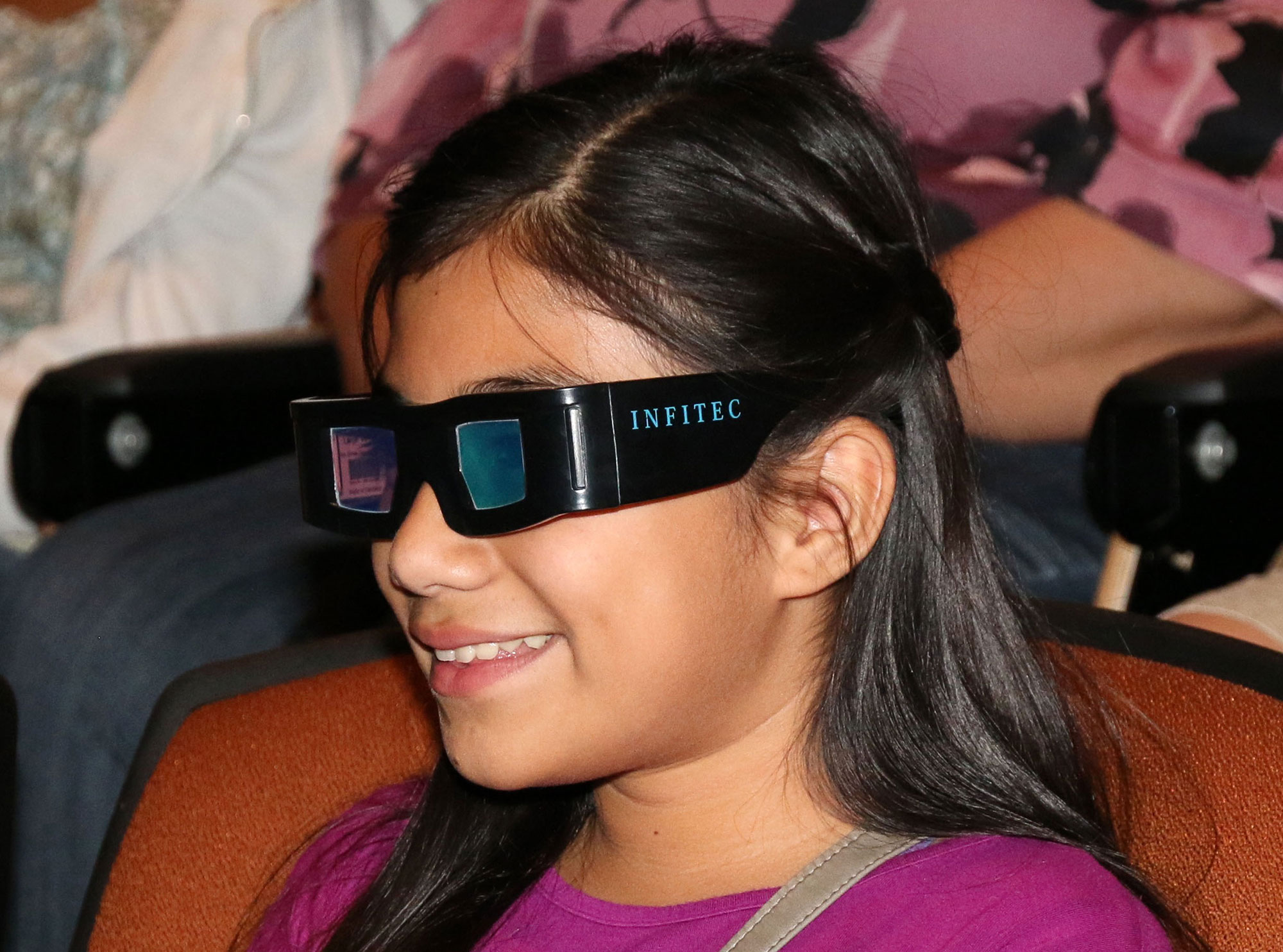 A girl prepares to watch a 3-D movie