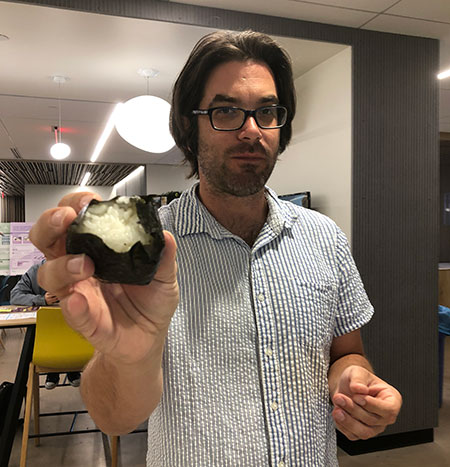 An ASU professor holds up his completed onigiri