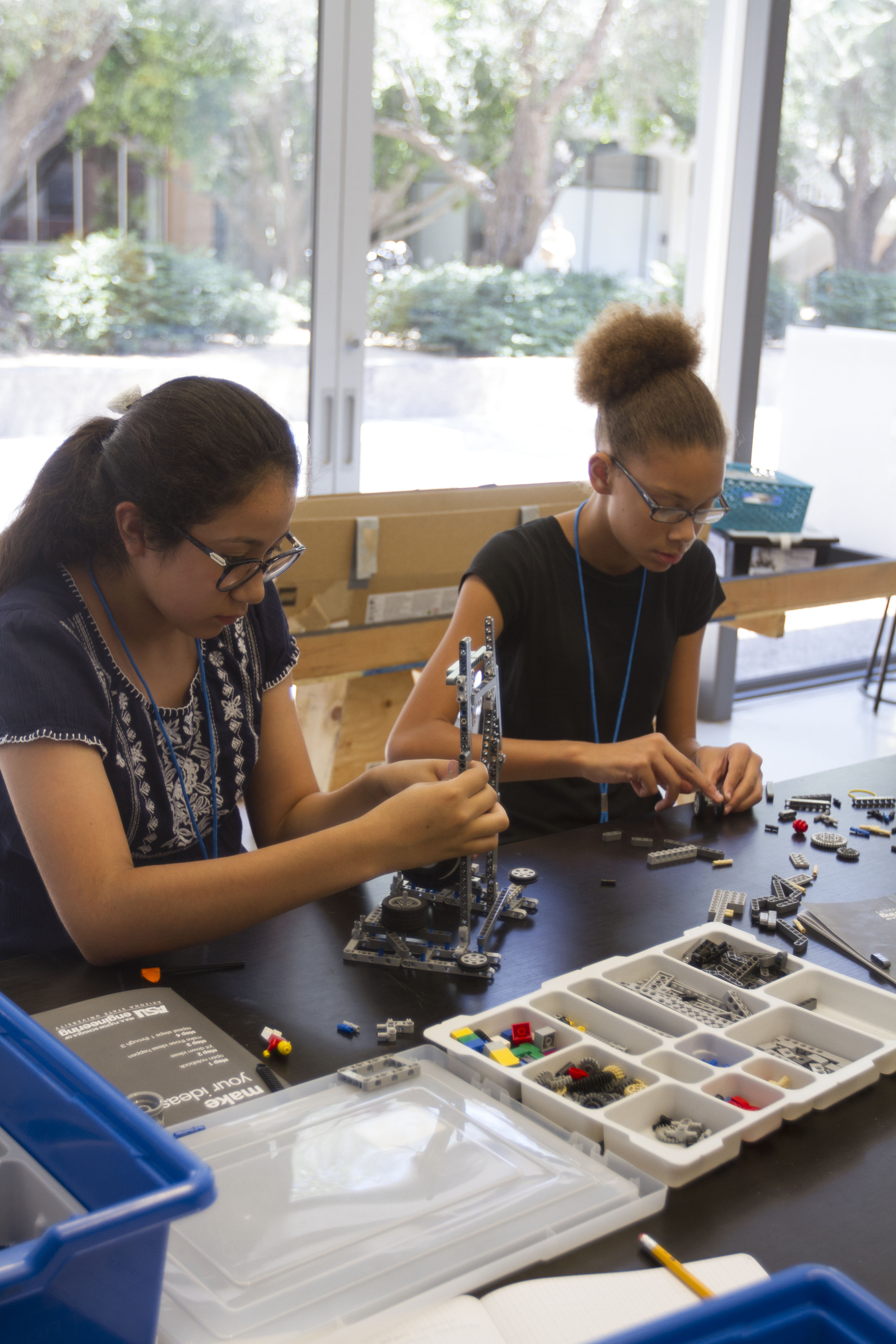 two students working with LEGOS