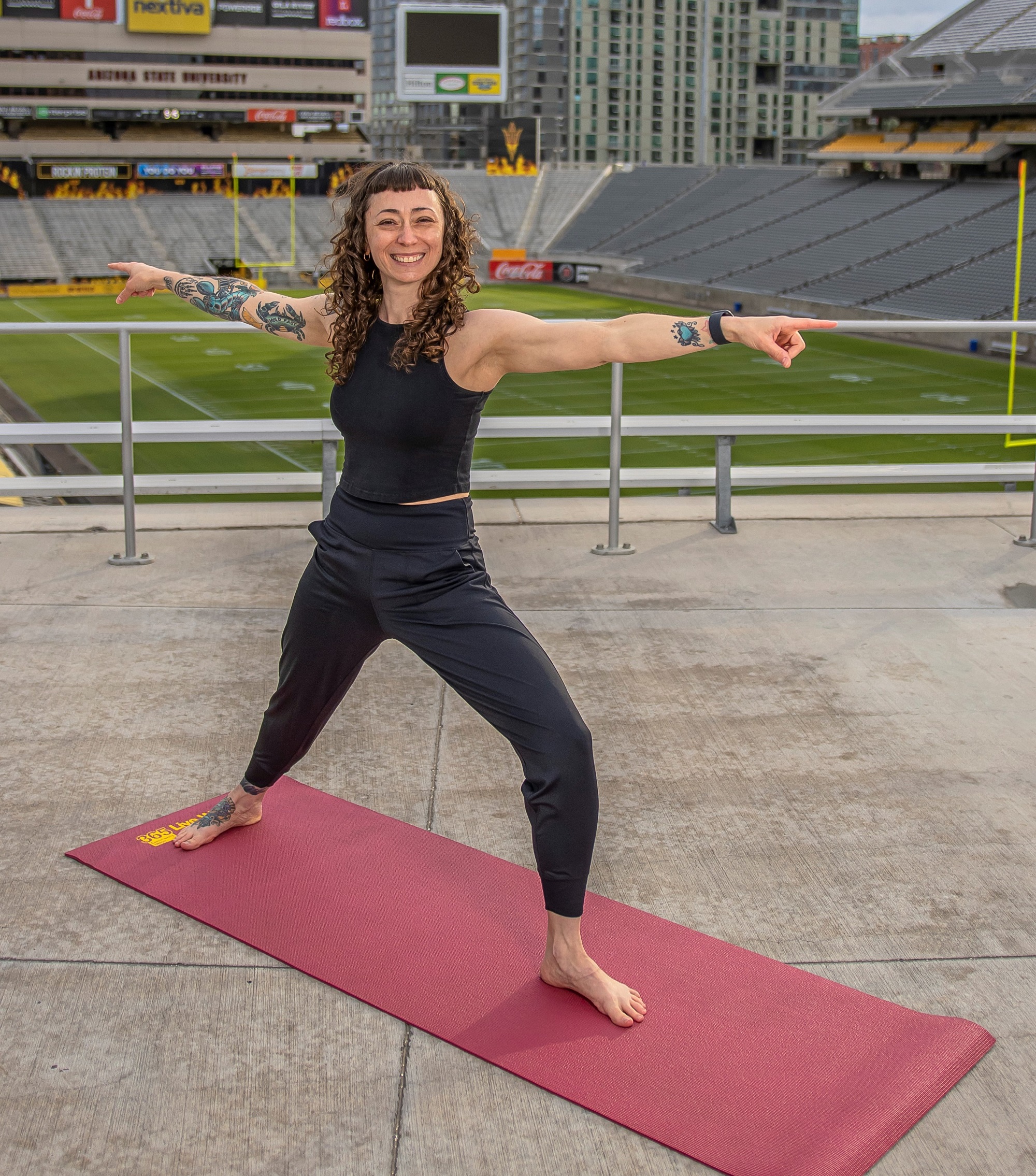Instructor  leads a yoga class from Sun Devil Stadium