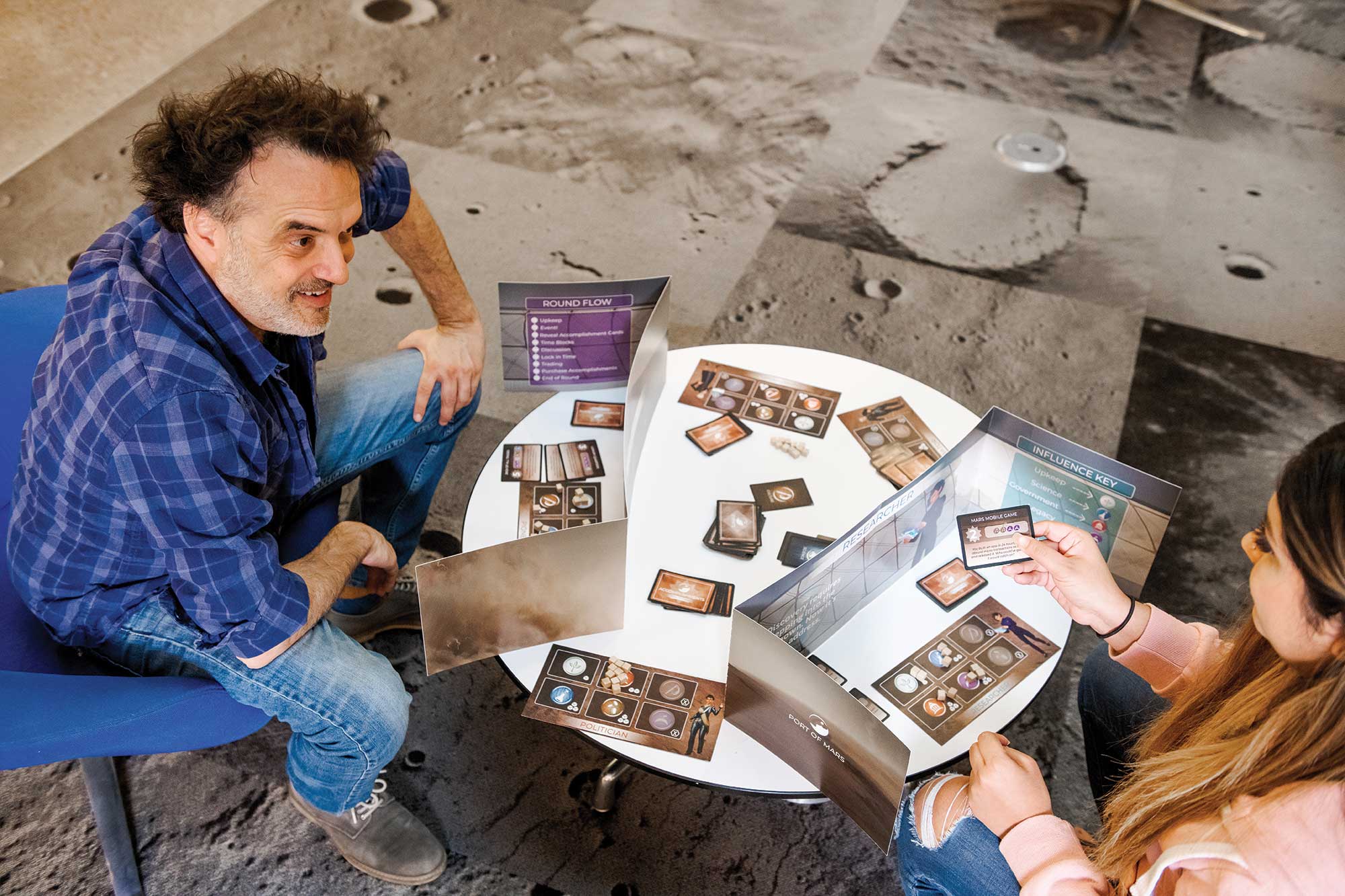 Two people play a Mars card game
