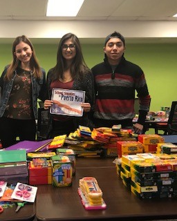 ASU students holding donated school supplies