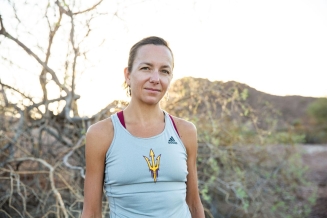 Victoria Jackson stands in a desert wearing a sun devils athletics tank and has her hair pulled back in a ponytail.