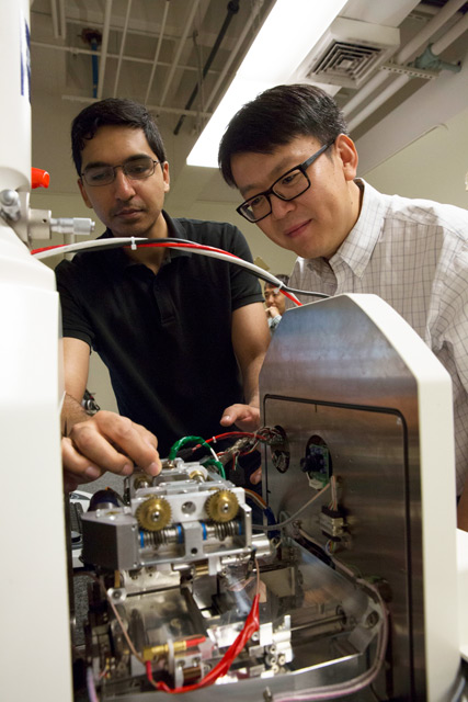 Photo of Yongming Liu and Fraaz Tahir working in a lab with a caption of "Professor Yongming Liu (right) pictured with Fraaz Tahir, a mechanical engineering doctoral student. Liu is leading a $10 million project funded by NASA to make next-generation avia